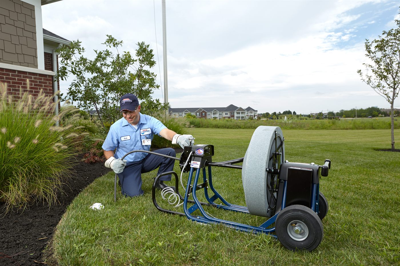 Roto-Rooter technician at an outdoor commercial cleanout
