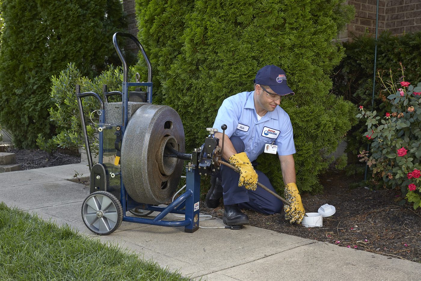 Roto-Rooter technician at an outdoor cleanout