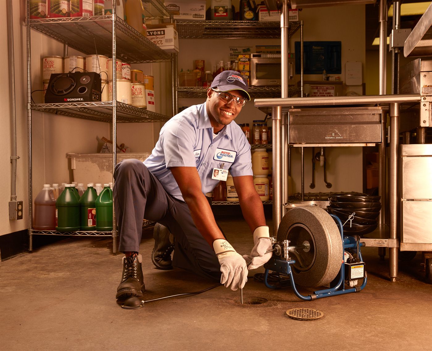 Roto-Rooter technician servicing a restaurant floor drain