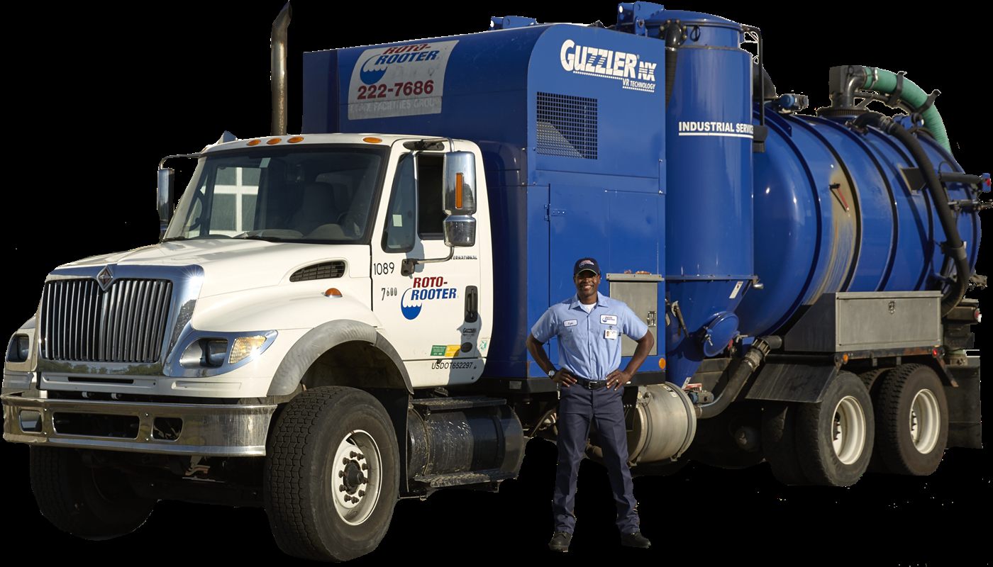 Roto-Rooter technician beside the septic pumping truck
