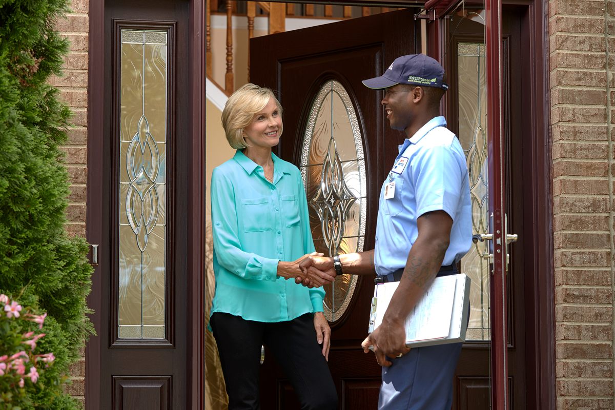 Roto-Rooter technician greeting a customer in Ammon